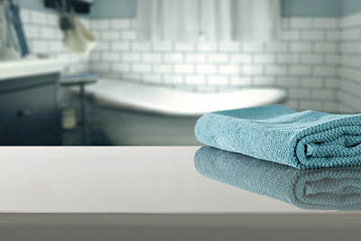 Blue blurred background of bathroom interior with towel.